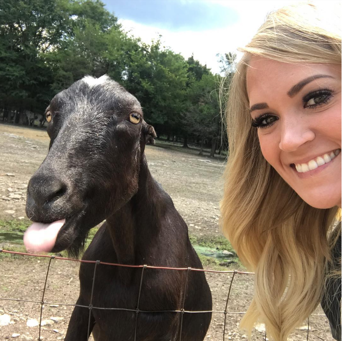 Carrie Underwood with a goat at Lucky Ladd Farms